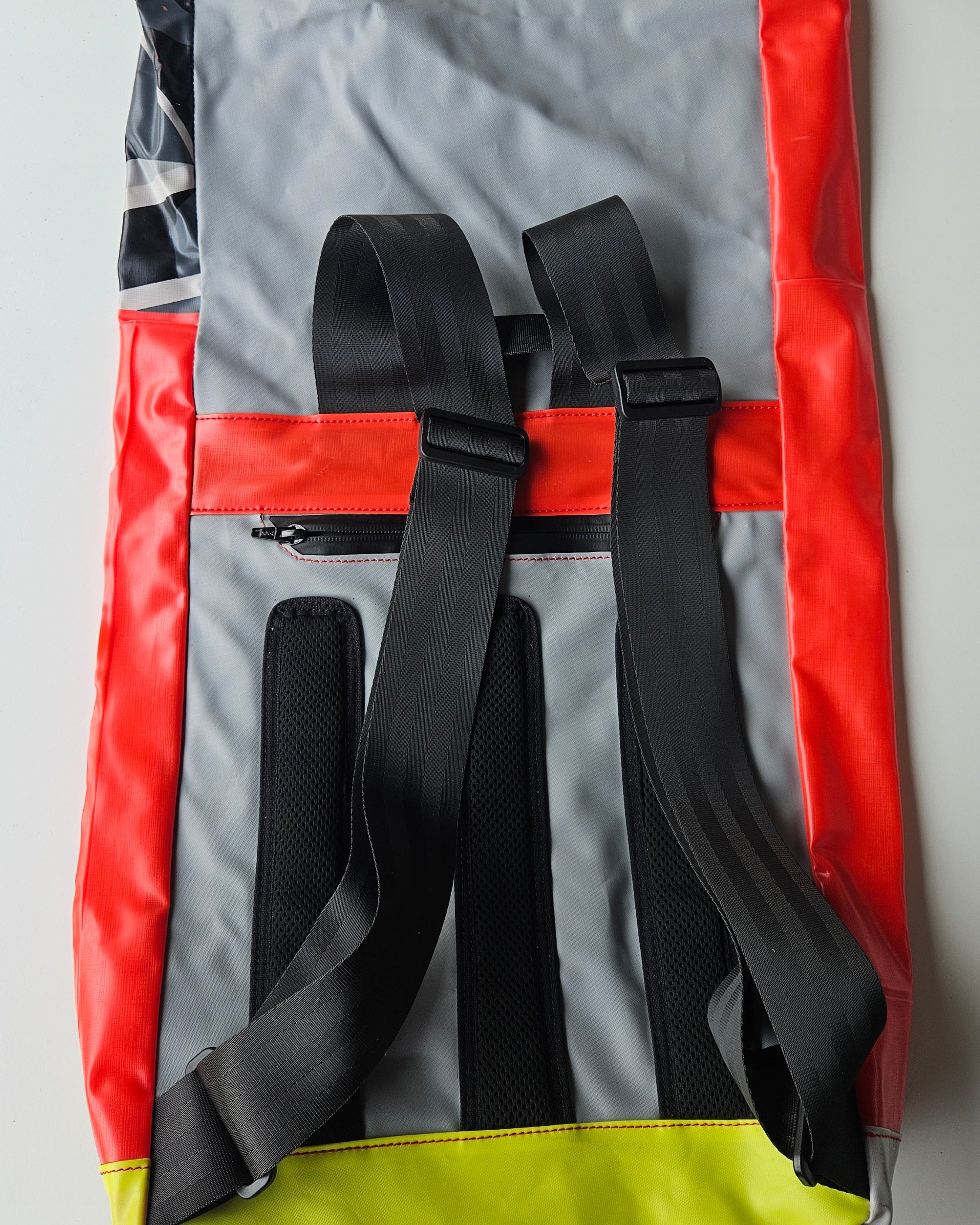 Roll backpack with straps on a gray background