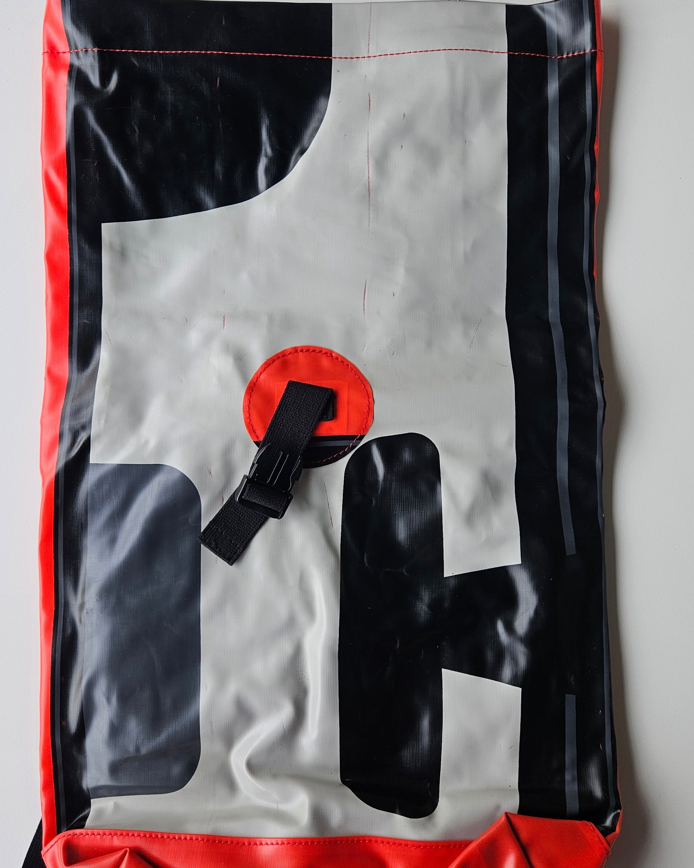 Bag with black, gray, and red design on a white background