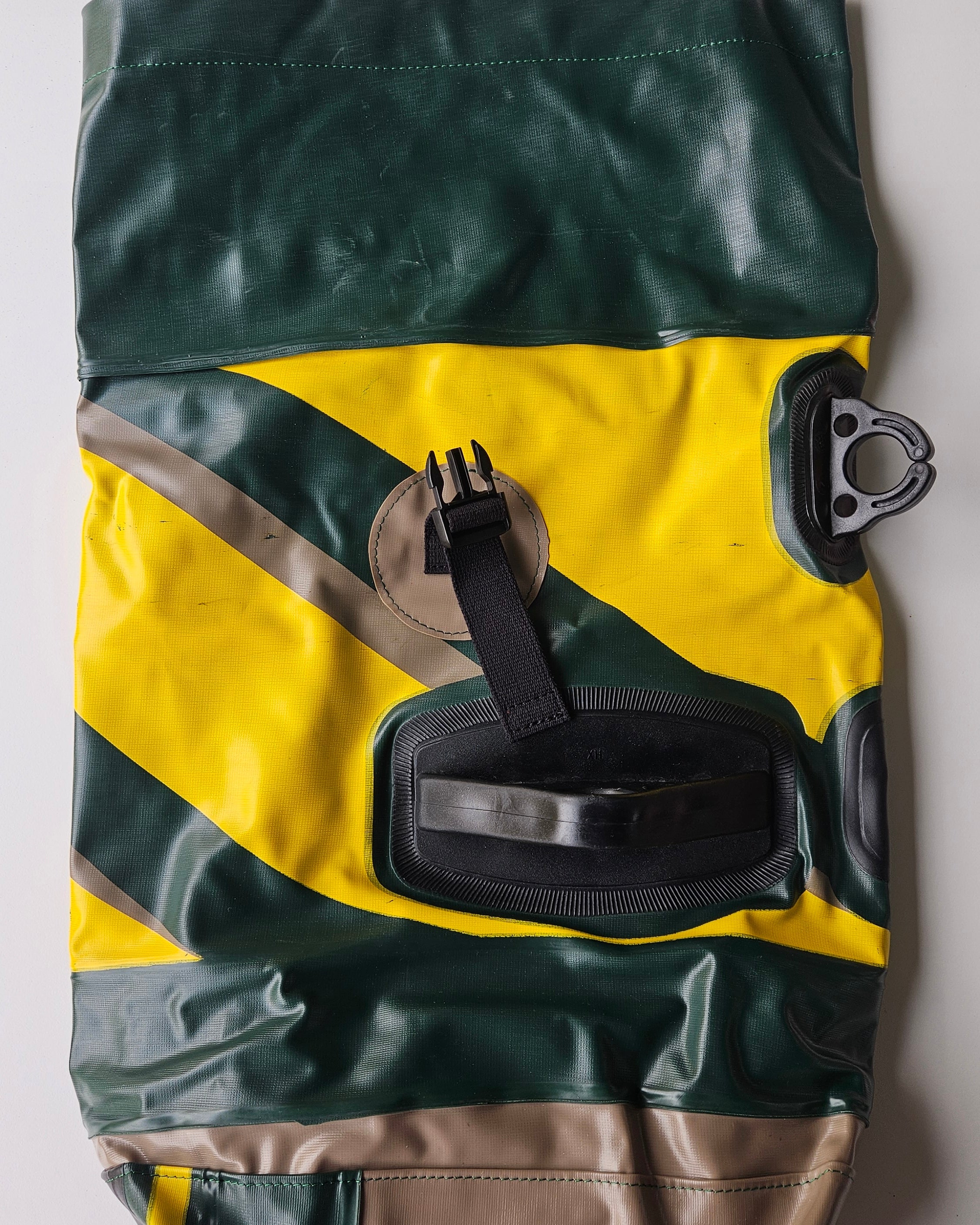 Green and yellow jacket with a logo on a white background