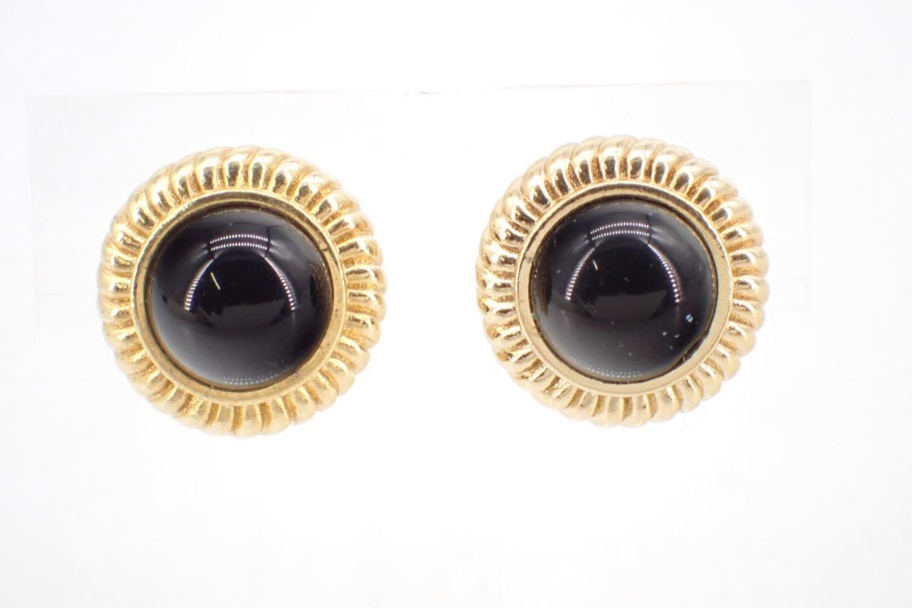 Pair of gold-framed black gemstone earrings on a white background