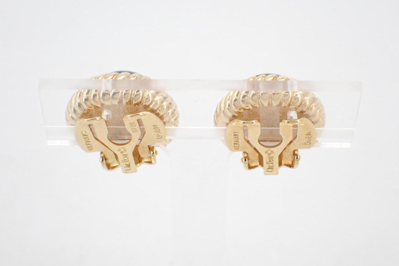 Pair of gold earrings on a white background