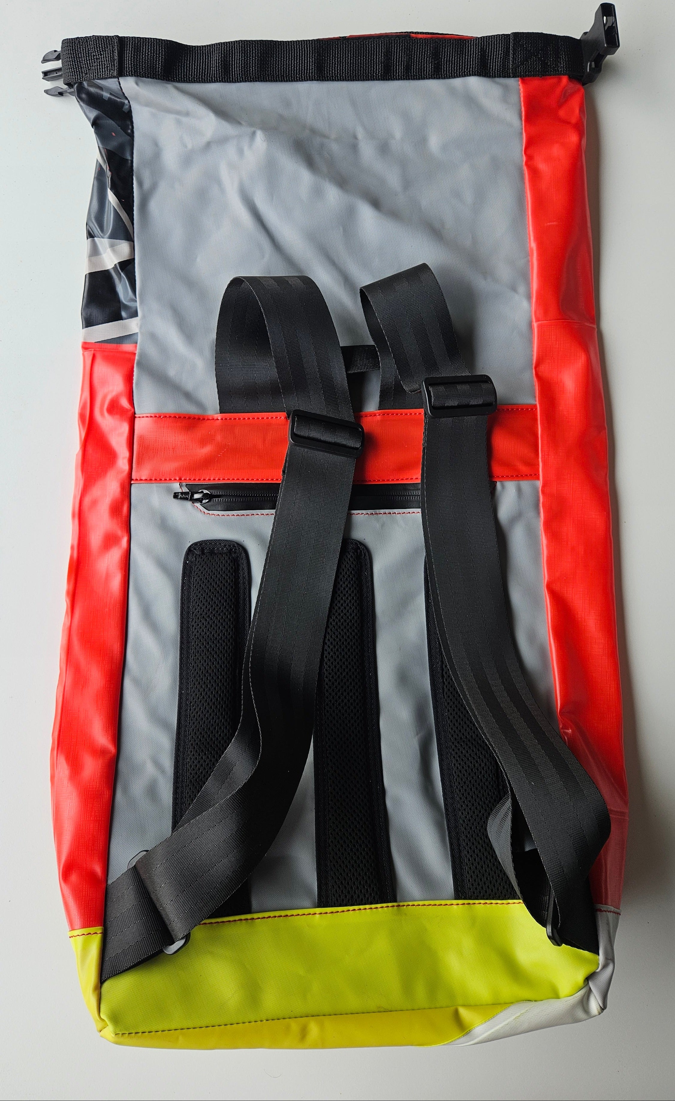 Roll backpack with straps on a gray background