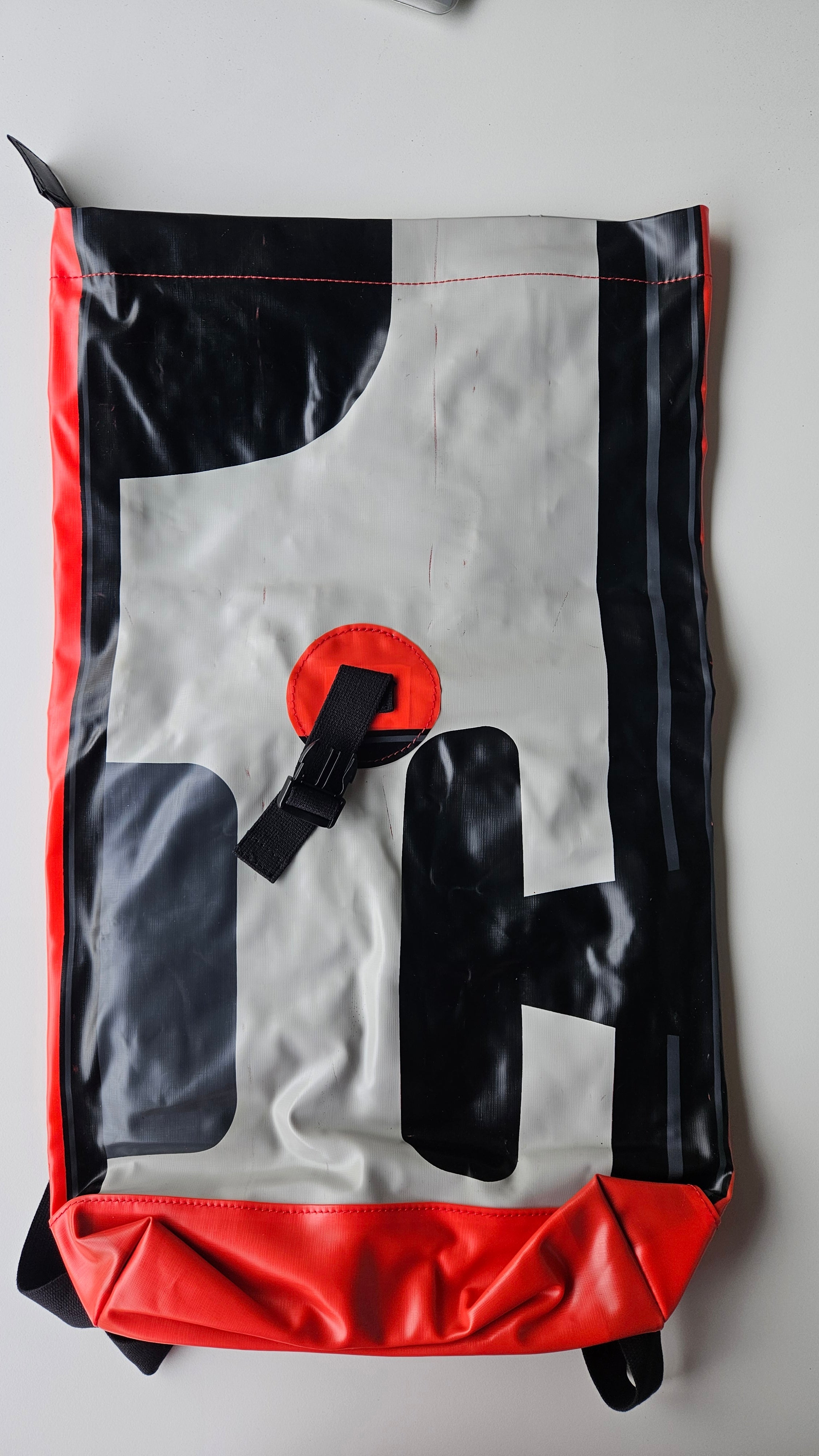 Bag with black, gray, and red design on a white background