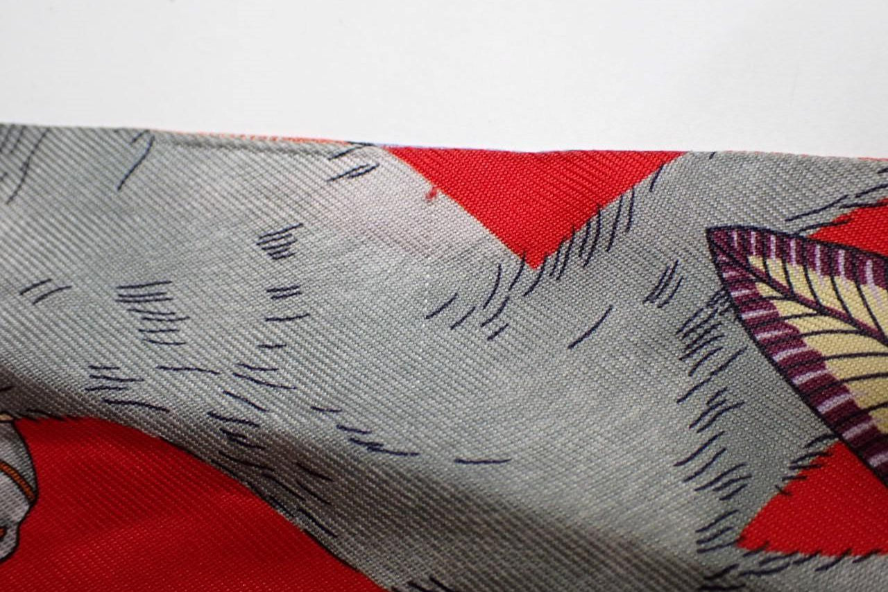 Close-up of fabric with red and gray pattern from Hermes secondhand TWILLY