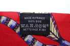 Textile label on a colorful fabric with 'Made in France' and other symbols.